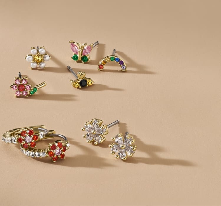 A GIF image of colourful crystal earrings and rings in garden-inspired floral designs.