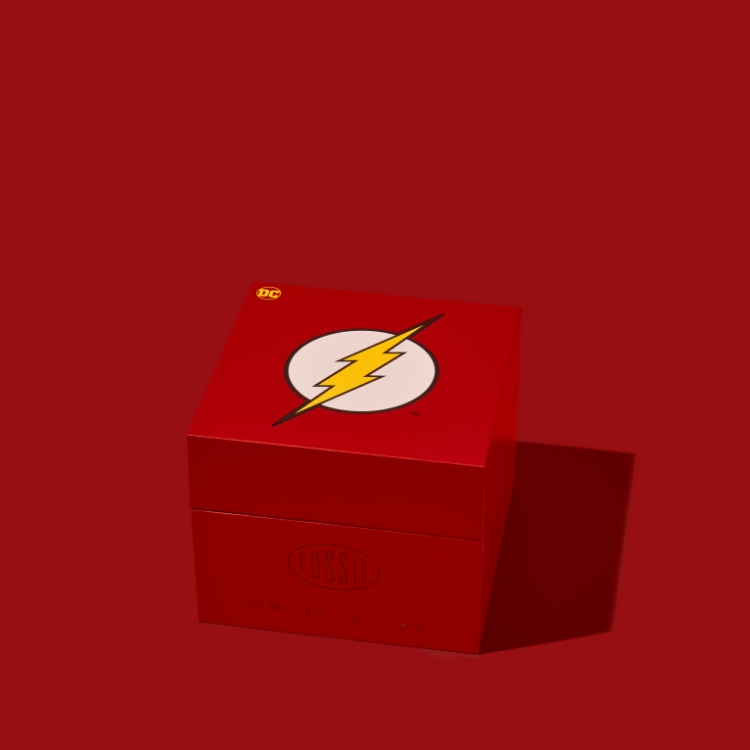 The Flash™ x Fossil watch packaging opening to reveal the limited edition watch inside. 